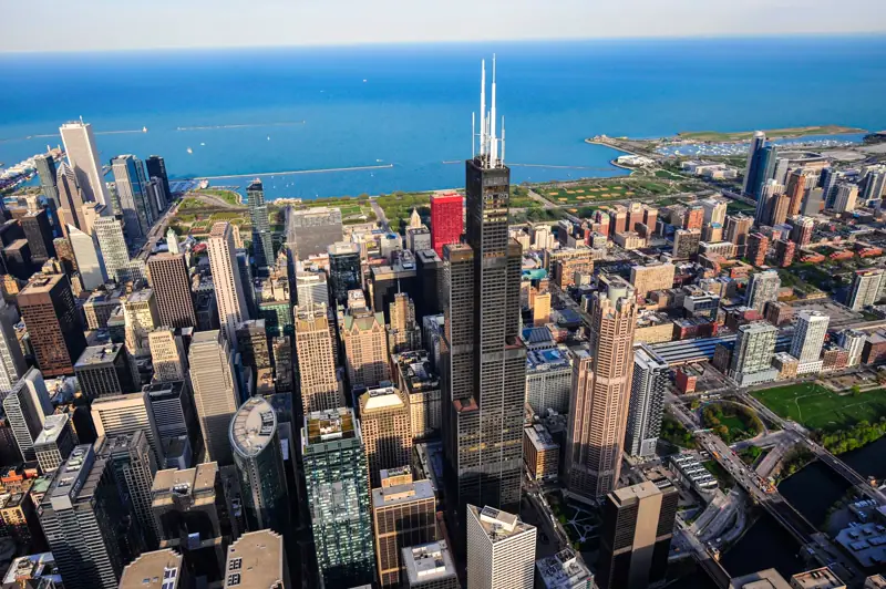 Aerial view of Willis Tower at the center of downtown Chicago with Lake Michigan behind